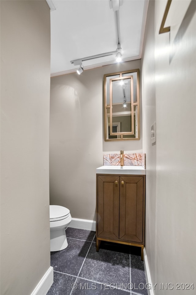 bathroom featuring vanity and toilet