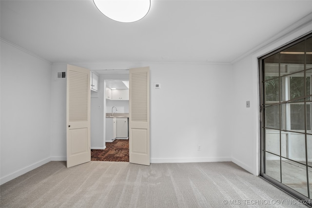 carpeted empty room with ornamental molding