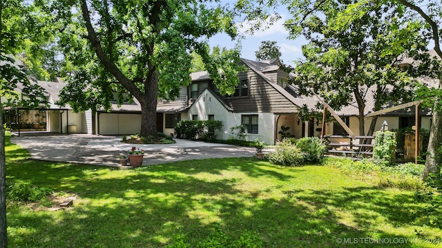 view of front of property with a front yard and a garage