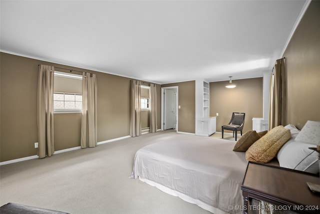 carpeted bedroom featuring crown molding