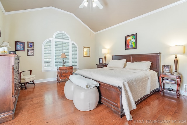 bedroom with ceiling fan, hardwood / wood-style flooring, lofted ceiling, and crown molding