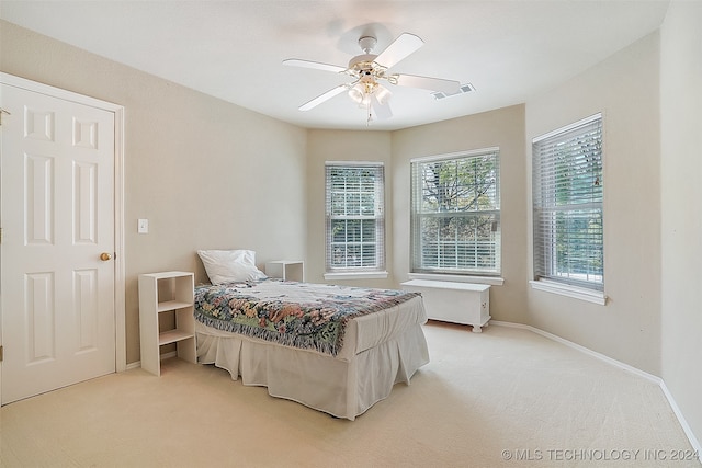 bedroom featuring light carpet and ceiling fan