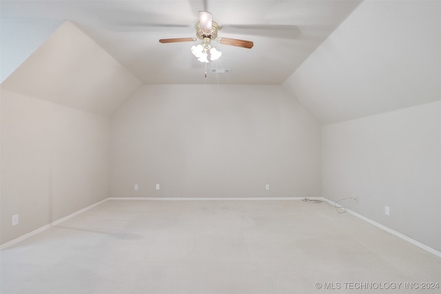 additional living space featuring ceiling fan, carpet, and vaulted ceiling