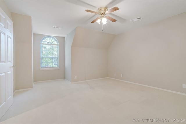 bonus room featuring light carpet, vaulted ceiling, and ceiling fan