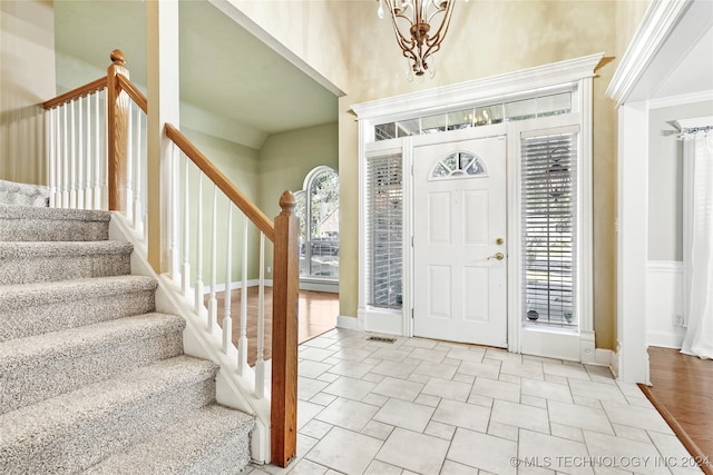 entrance foyer with light hardwood / wood-style flooring and a high ceiling