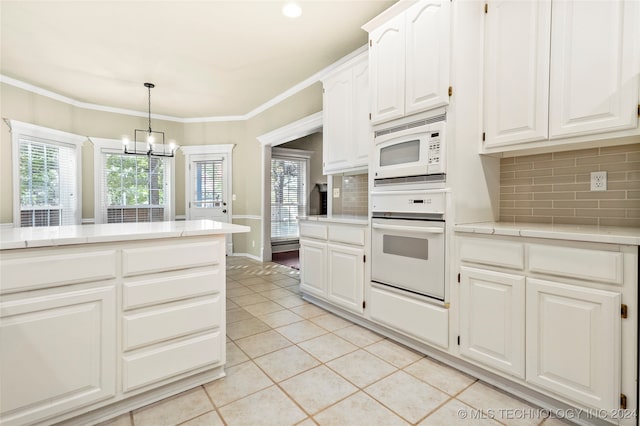 kitchen with decorative backsplash, white cabinets, a chandelier, pendant lighting, and white appliances