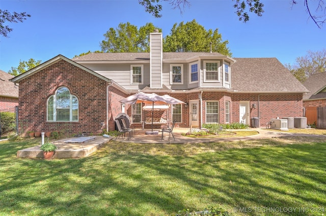 back of house with a patio area, a lawn, and central AC unit