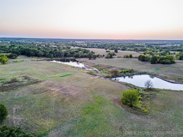 aerial view at dusk with a water view