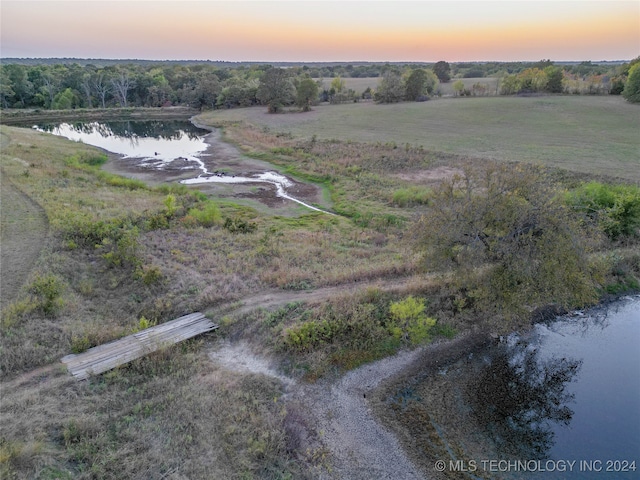 aerial view at dusk with a water view