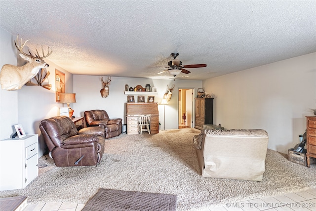 living room with ceiling fan, light carpet, and a textured ceiling