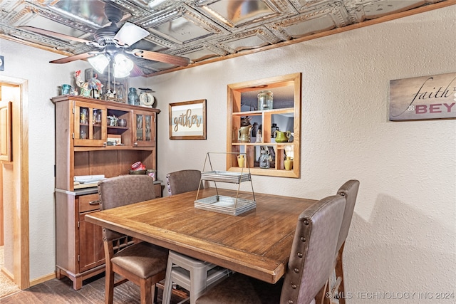 dining area featuring hardwood / wood-style floors, coffered ceiling, and ceiling fan