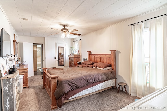 bedroom with crown molding, ensuite bath, light colored carpet, and ceiling fan