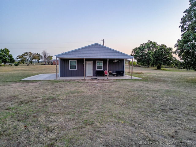 view of front of home featuring covered porch and a lawn