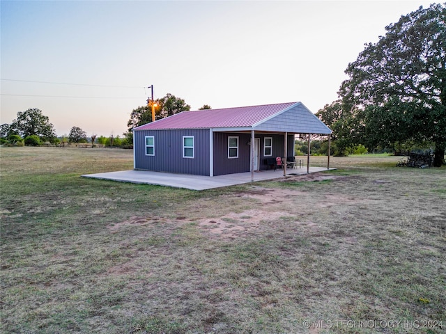 view of front of home featuring a patio area and a lawn