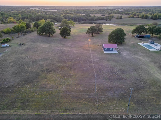 aerial view at dusk featuring a rural view