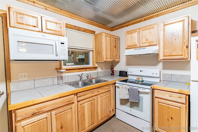 kitchen with light brown cabinets, tile countertops, ornamental molding, sink, and white appliances