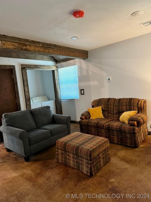 carpeted living room with beam ceiling, independent washer and dryer, and a textured ceiling