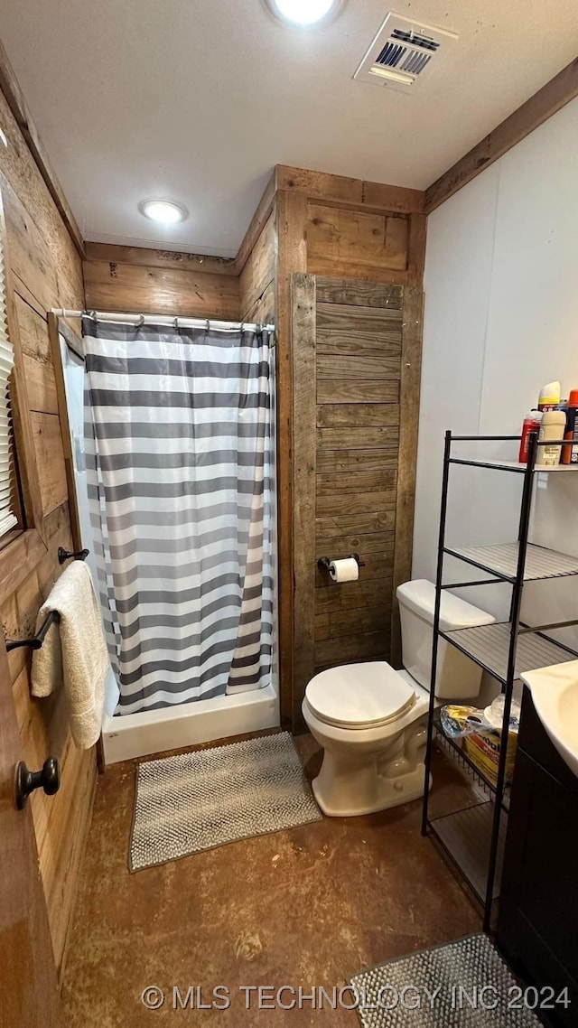 bathroom with toilet, wood walls, vanity, and a shower with shower curtain