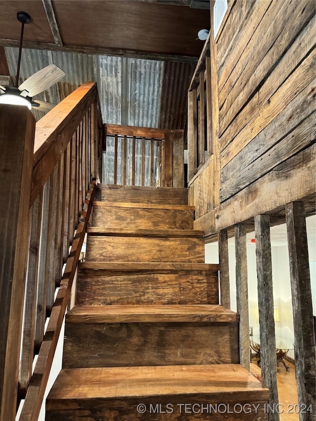 staircase with wood walls