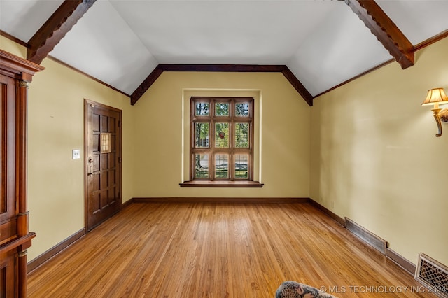 entrance foyer with lofted ceiling with beams and light wood-type flooring