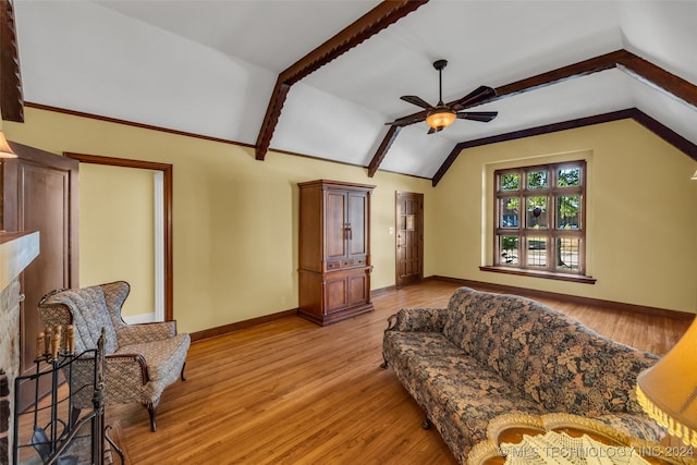 living room featuring lofted ceiling with beams, light wood-type flooring, and ceiling fan