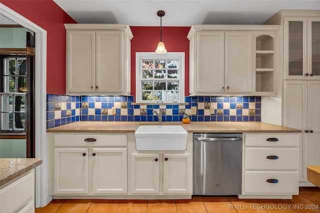 kitchen with tasteful backsplash, light stone countertops, sink, hanging light fixtures, and stainless steel dishwasher