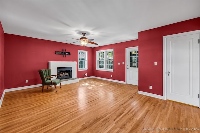 unfurnished living room with light hardwood / wood-style floors and ceiling fan