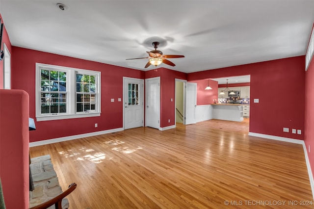 unfurnished living room with ceiling fan and light hardwood / wood-style flooring