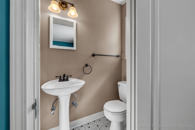 bathroom featuring toilet, tile patterned floors, and sink