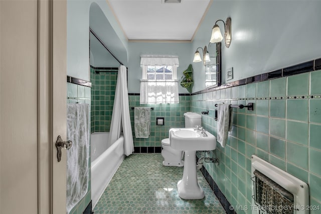 bathroom with tile walls, toilet, ornamental molding, shower / bath combo, and tile patterned flooring