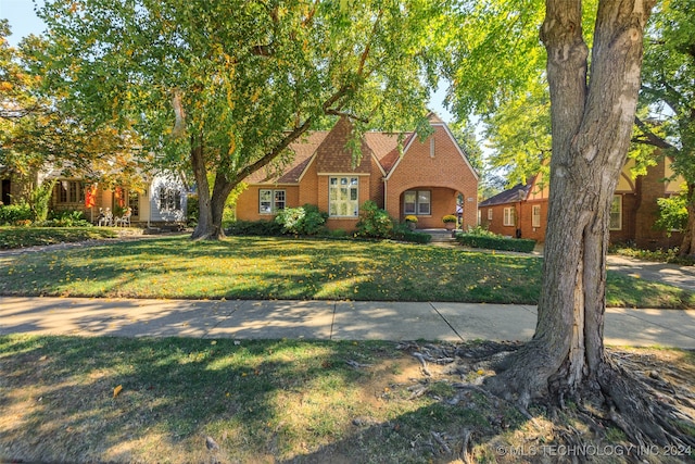 english style home with a front lawn