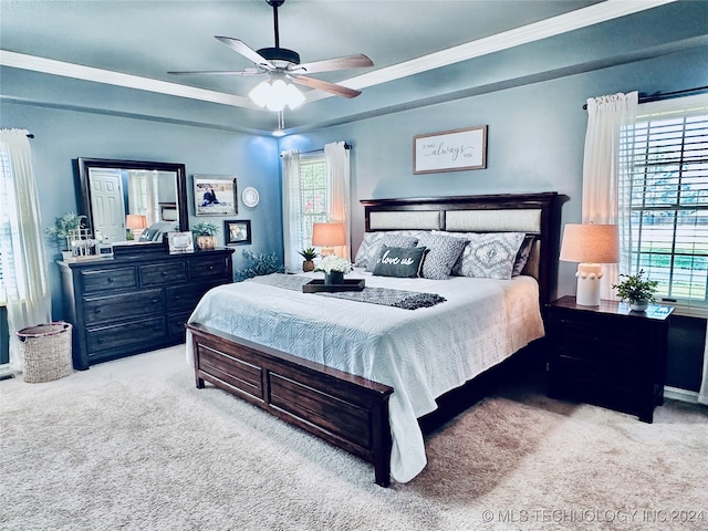 carpeted bedroom with multiple windows, ornamental molding, and ceiling fan