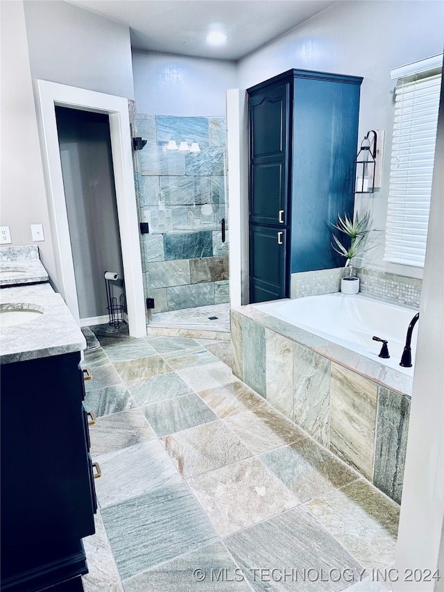 bathroom with vanity and independent shower and bath