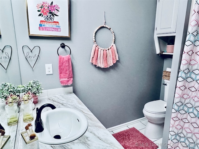 bathroom featuring vanity, toilet, and tile patterned flooring