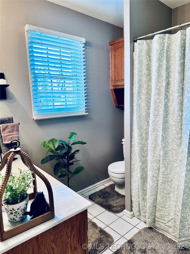 bathroom featuring vanity, toilet, and tile patterned flooring