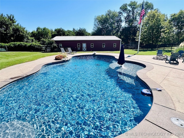 view of swimming pool featuring a patio area, a yard, and a diving board