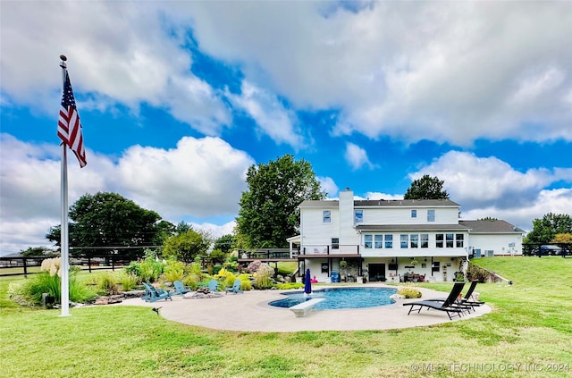 back of property with a patio and a lawn