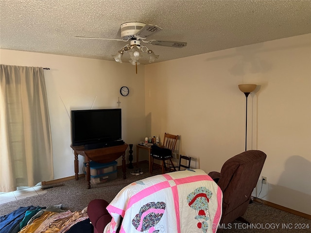 carpeted living room with ceiling fan and a textured ceiling