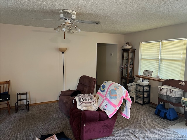 carpeted living room featuring a textured ceiling and ceiling fan