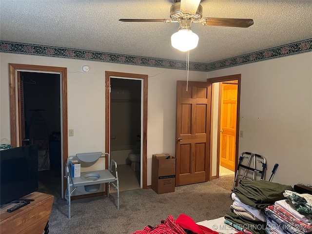 carpeted bedroom featuring ceiling fan, a textured ceiling, and ensuite bathroom