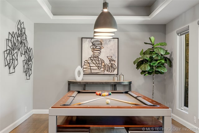 playroom featuring hardwood / wood-style floors, pool table, and a tray ceiling