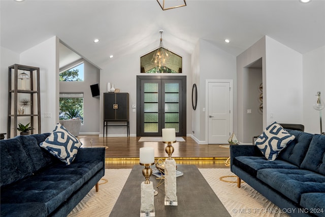 living room with high vaulted ceiling and hardwood / wood-style flooring