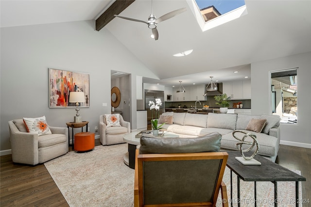 living room with ceiling fan, high vaulted ceiling, beamed ceiling, dark wood-type flooring, and a skylight