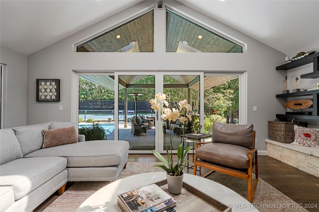 living room featuring vaulted ceiling, a wealth of natural light, and dark hardwood / wood-style flooring