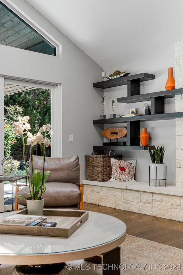 living room with lofted ceiling, hardwood / wood-style floors, and plenty of natural light