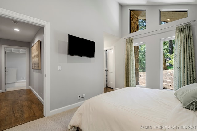 bedroom with carpet and a towering ceiling