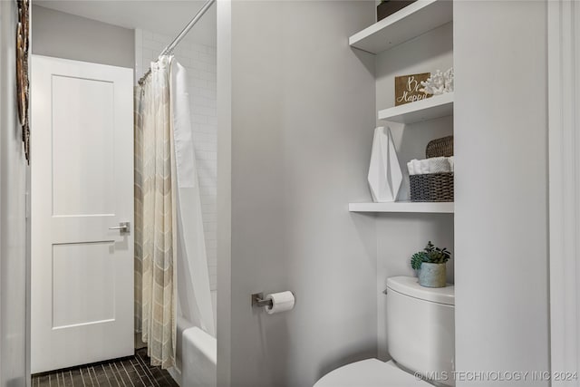 bathroom featuring toilet and shower / bathtub combination with curtain