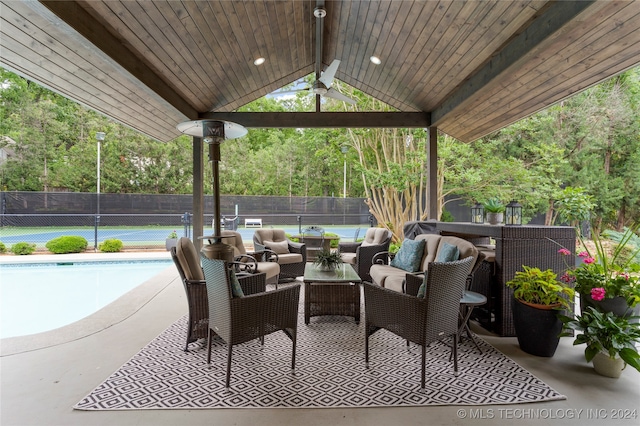 view of patio with a gazebo, a fenced in pool, and ceiling fan