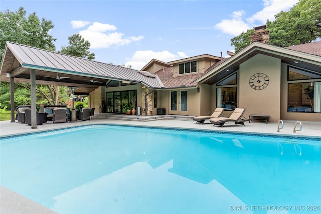 view of pool featuring an outdoor hangout area, a patio, and ceiling fan