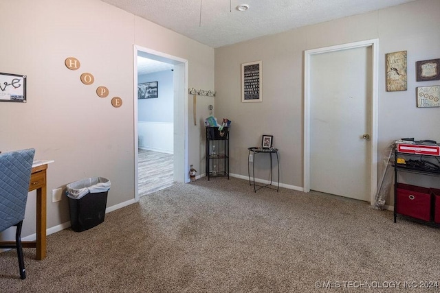 carpeted office space featuring baseboards